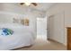 Bright bedroom showcases neutral walls, palm tree art, and closet with sliding doors at 2104 Batello Dr, Venice, FL 34292