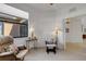 Relaxing bedroom featuring lounge chairs, lamps, neutral walls and natural light at 2104 Batello Dr, Venice, FL 34292