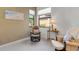 Relaxing bedroom featuring lounge chairs, table, neutral walls and natural light at 2104 Batello Dr, Venice, FL 34292