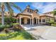 Exterior view of the clubhouse entrance featuring manicured landscaping and covered entry at 2104 Batello Dr, Venice, FL 34292
