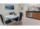 Modern dining area with a view of the kitchen featuring a glass table and seating at 2104 Batello Dr, Venice, FL 34292
