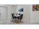 Contemporary dining area with modern chairs, a glass table, and neutral paint at 2104 Batello Dr, Venice, FL 34292