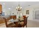 Dining room with glass table adjacent to a kitchen with granite counters and stainless appliances at 2104 Batello Dr, Venice, FL 34292