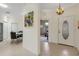 Welcoming foyer with tile flooring, neutral paint, and views of the dining area and living room at 2104 Batello Dr, Venice, FL 34292