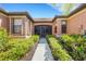 Inviting single-story home with lush landscaping and a screened front entry at 2104 Batello Dr, Venice, FL 34292