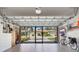 Well-lit garage with overhead door open to an outside view, and storage cabinets for organization at 2104 Batello Dr, Venice, FL 34292