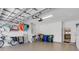 Well-organized garage featuring ample storage space, bicycles, and equipment neatly arranged on the walls at 2104 Batello Dr, Venice, FL 34292