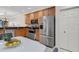 Bright kitchen features stainless steel appliances, wooden cabinetry, and a tiled backsplash at 2104 Batello Dr, Venice, FL 34292