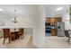 View of kitchen with stainless appliances and adjacent dining room with elegant chandelier at 2104 Batello Dr, Venice, FL 34292