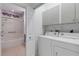 Convenient laundry room with washer, dryer, cabinets and access to the adjacent bathroom with tub/shower at 2104 Batello Dr, Venice, FL 34292