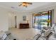 Comfortable living room with sliding glass doors to the screened patio and neutral colored furniture at 2104 Batello Dr, Venice, FL 34292
