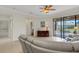 Comfortable living room with sliding glass doors to the screened patio and neutral colored furniture at 2104 Batello Dr, Venice, FL 34292