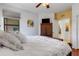 Relaxing main bedroom with wood floors, modern ceiling fan, and view of the ensuite at 2104 Batello Dr, Venice, FL 34292