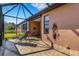 Relaxing screened-in patio with tile flooring, offering a perfect space for outdoor enjoyment and entertainment at 2104 Batello Dr, Venice, FL 34292