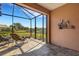 Enclosed patio with tiled flooring overlooking serene outdoor views and seating area at 2104 Batello Dr, Venice, FL 34292