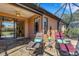 Comfortable screened-in patio featuring tile flooring, lounge chairs, and access to the home's interior at 2104 Batello Dr, Venice, FL 34292