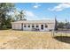 An expansive backyard offers space for relaxation and recreation with seating and a trampoline at 219 Capatola St, Port Charlotte, FL 33948