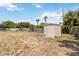 A spacious backyard with lush greenery and a storage shed offers endless possibilities for outdoor enjoyment at 219 Capatola St, Port Charlotte, FL 33948