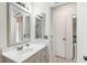 Bathroom features a white vanity, a large mirror, and plenty of natural light at 219 Capatola St, Port Charlotte, FL 33948