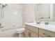 Well-lit bathroom offers a shower/tub combo with white tiles, neutral walls and a vanity at 219 Capatola St, Port Charlotte, FL 33948
