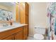 Cozy bathroom features a wood vanity, a large mirror, and unique shower curtain at 219 Capatola St, Port Charlotte, FL 33948