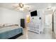 Bright bedroom with tile floors, a ceiling fan, and a crib for a growing Gathering at 219 Capatola St, Port Charlotte, FL 33948