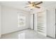 Bright bedroom with tile floors, a ceiling fan, a window with blinds, and a bookshelf at 219 Capatola St, Port Charlotte, FL 33948