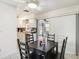 Comfortable dining area features a modern light fixture, tile floors, and a view of the kitchen at 219 Capatola St, Port Charlotte, FL 33948