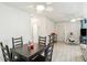 Bright dining area featuring tile floors, ceiling fan, and view of the living room at 219 Capatola St, Port Charlotte, FL 33948