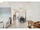 Bright dining area with modern flooring and slider door to screened porch, adjacent to kitchen and living room at 219 Capatola St, Port Charlotte, FL 33948