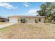 Charming single-story home featuring a well-maintained lawn, neutral stucco, and an attached one-car garage at 219 Capatola St, Port Charlotte, FL 33948