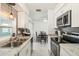 Efficient kitchen featuring stainless appliances, bright white cabinets, granite countertops, and a modern design at 219 Capatola St, Port Charlotte, FL 33948
