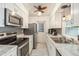 Galley kitchen featuring white cabinets, stainless steel appliances, and granite countertops for modern appeal at 219 Capatola St, Port Charlotte, FL 33948