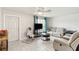 Cozy living room with tile floors, ceiling fan, natural light, and comfortable seating perfect for relaxation at 219 Capatola St, Port Charlotte, FL 33948
