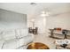 Open-concept living room featuring neutral walls, tile floors, ceiling fan, and comfortable seating at 219 Capatola St, Port Charlotte, FL 33948