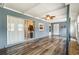 A bright sunroom features wood floors, access to the kitchen, and ample space for relaxation and entertaining at 219 Capatola St, Port Charlotte, FL 33948
