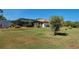Large backyard showcasing mature trees, manicured lawn, and screened pool area at 2194 Abalom St, Punta Gorda, FL 33980