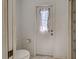 Bathroom features a toilet and windowed door to the backyard with a purple curtain at 2194 Abalom St, Punta Gorda, FL 33980