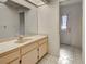 Bright bathroom featuring a single sink vanity with tile flooring and windowed door to the backyard at 2194 Abalom St, Punta Gorda, FL 33980