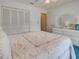 Bedroom featuring a bed, closet, dresser with a round mirror and green carpet at 2194 Abalom St, Punta Gorda, FL 33980
