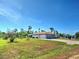 Spacious home featuring a two-car garage, a paved driveway, and a sizable front yard at 2194 Abalom St, Punta Gorda, FL 33980