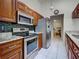 Well-lit kitchen features stainless steel appliances and granite countertops with tile flooring at 2194 Abalom St, Punta Gorda, FL 33980