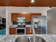 Updated kitchen features stainless steel appliances, granite countertops, and dark wood cabinetry at 2194 Abalom St, Punta Gorda, FL 33980