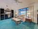 Bright living room featuring a vaulted ceiling, ceiling fan and comfortable seating at 2194 Abalom St, Punta Gorda, FL 33980