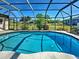 Sparkling enclosed pool area surrounded by lush landscaping and a spacious deck, ideal for entertaining at 2194 Abalom St, Punta Gorda, FL 33980
