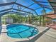 Well-maintained enclosed pool area with an outdoor dining and relaxing area, perfect for entertaining at 2194 Abalom St, Punta Gorda, FL 33980