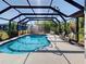 Enclosed pool area with a spacious deck and comfortable seating, perfect for relaxation at 2194 Abalom St, Punta Gorda, FL 33980