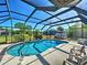 Enclosed pool area featuring a spacious patio and well-maintained landscaping for serene outdoor living at 2194 Abalom St, Punta Gorda, FL 33980