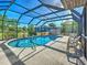 Enclosed pool and deck with landscaping at 2194 Abalom St, Punta Gorda, FL 33980