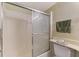 Bathroom featuring a shower with sliding doors, vanity, and toilet at 232 Saint Augustine Ave # 701, Venice, FL 34285